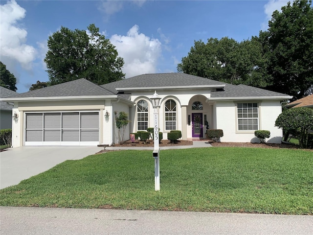 11605 SW 69th Cir, Ocala, FL 34476 - ranch-style home with an attached garage, a front lawn, concrete driveway, stucco siding, and roof with shingles