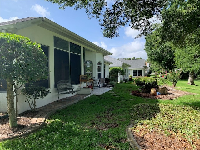 11605 SW 69th Cir, Ocala, FL 34476 - view of green lawn with a patio area