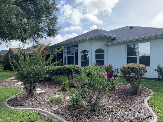 11605 SW 69th Cir, Ocala, FL 34476 - view of side of home featuring stucco siding and roof with shingles