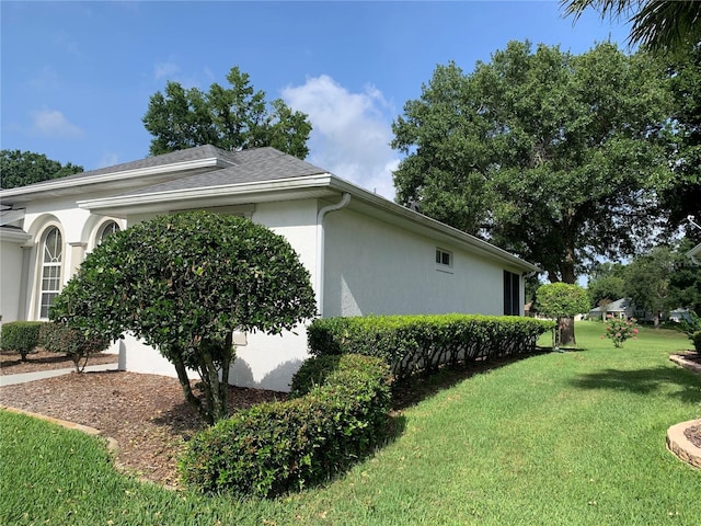 11605 SW 69th Cir, Ocala, FL 34476 - view of home's exterior with a lawn and stucco siding