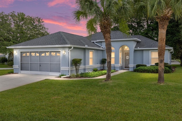 11051 SW 73rd Ct, Ocala, FL 34476 - ranch-style house featuring stucco siding, driveway, a garage, a shingled roof, and a front lawn