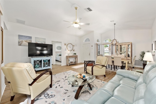 11051 SW 73rd Ct, Ocala, FL 34476 - living area featuring a ceiling fan, lofted ceiling, light wood-style floors, a chandelier, and baseboards