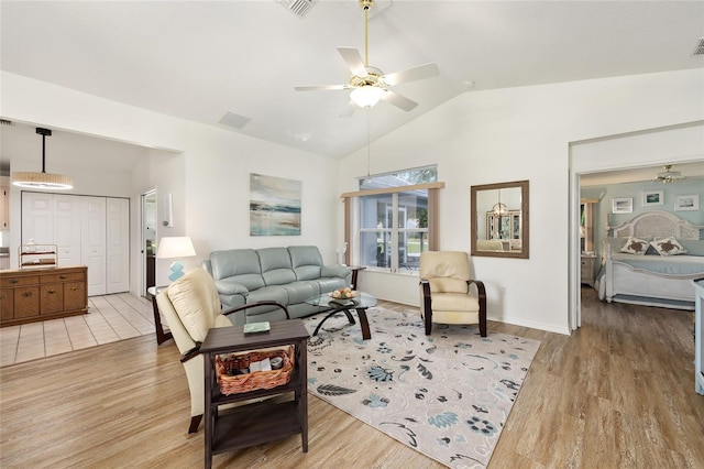 11051 SW 73rd Ct, Ocala, FL 34476 - living area featuring a ceiling fan, light wood-type flooring, baseboards, and high vaulted ceiling