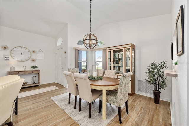 11051 SW 73rd Ct, Ocala, FL 34476 - dining area featuring a chandelier, light wood-style flooring, baseboards, and high vaulted ceiling