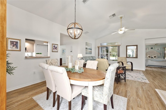 11051 SW 73rd Ct, Ocala, FL 34476 - dining space featuring ceiling fan, light wood finished floors, vaulted ceiling, a chandelier, and baseboards