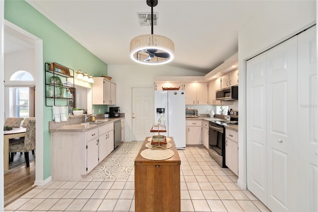 11051 SW 73rd Ct, Ocala, FL 34476 - kitchen featuring appliances with stainless steel finishes, a sink, lofted ceiling, light countertops, and a ceiling fan