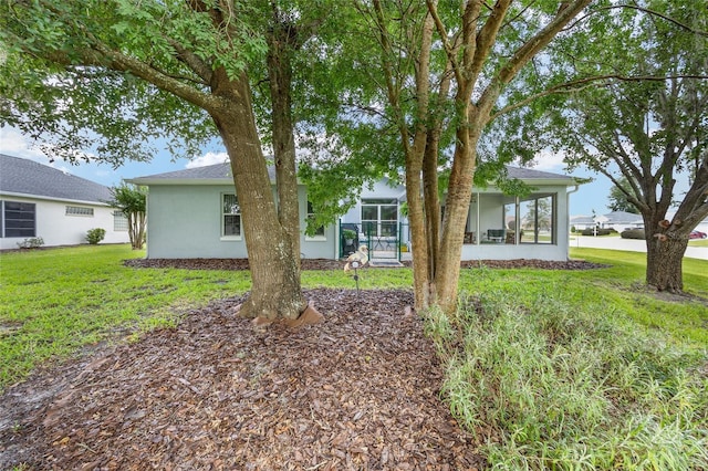 11051 SW 73rd Ct, Ocala, FL 34476 - rear view of property featuring a yard, a sunroom, and stucco siding