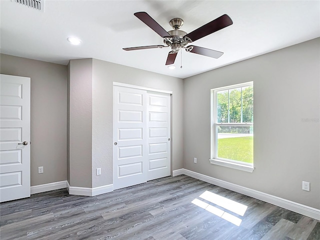 226 Locust Ln, Ocala, FL 34472 - unfurnished bedroom featuring wood finished floors, a closet, recessed lighting, and a ceiling fan