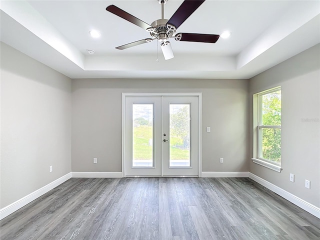 226 Locust Ln, Ocala, FL 34472 - empty room featuring a tray ceiling, wood finished floors, ceiling fan, a smoke detector, and recessed lighting