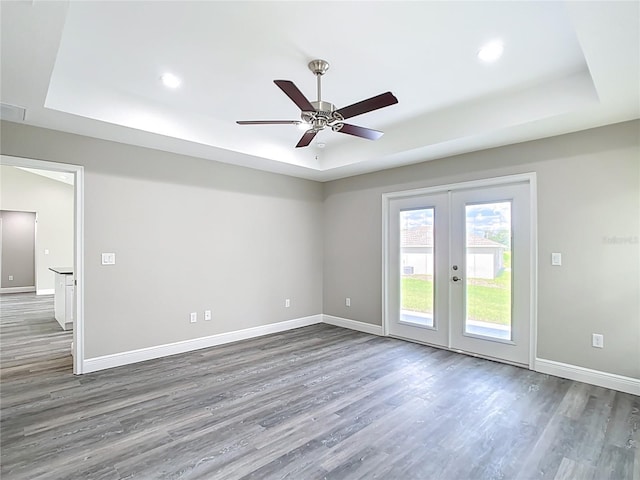 226 Locust Ln, Ocala, FL 34472 - empty room with a raised ceiling, wood finished floors, french doors, and recessed lighting