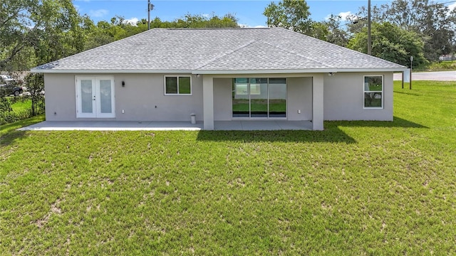 226 Locust Ln, Ocala, FL 34472 - back of house featuring roof with shingles, stucco siding, a patio, french doors, and a lawn