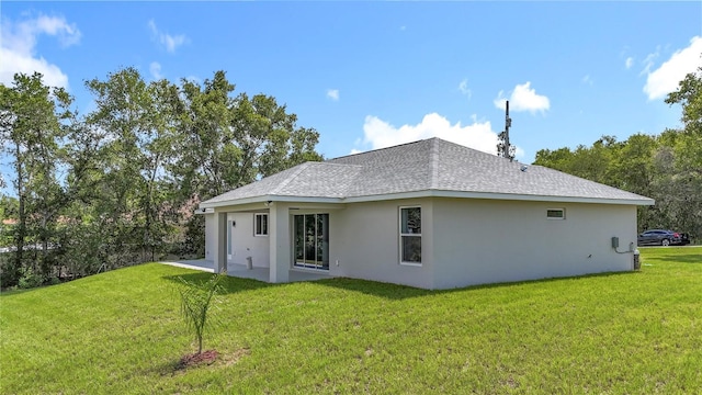 226 Locust Ln, Ocala, FL 34472 - rear view of house with a yard, stucco siding, roof with shingles, and a patio