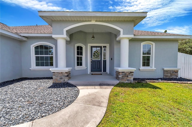 12392 SW 85th Pl, Dunnellon, FL 34432 - view of exterior entry with roof with shingles and stucco siding