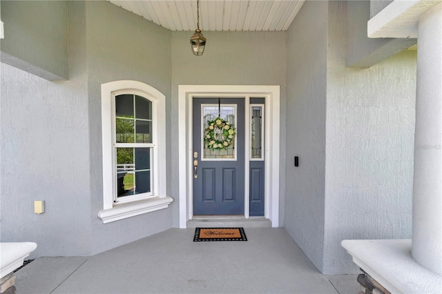 12392 SW 85th Pl, Dunnellon, FL 34432 - view of exterior entry featuring stucco siding and covered porch