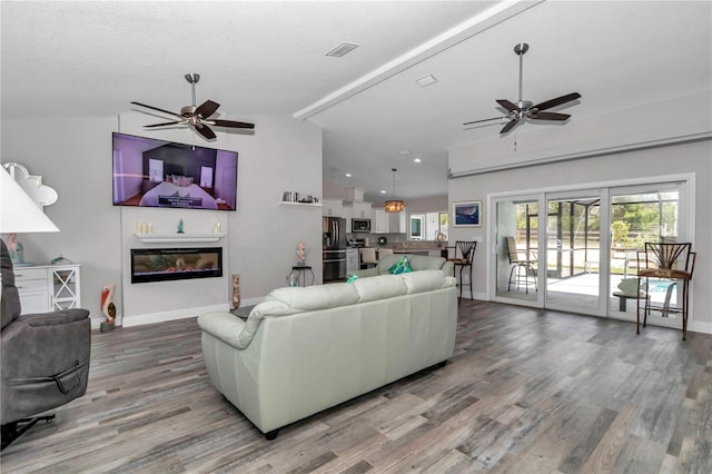 12392 SW 85th Pl, Dunnellon, FL 34432 - living area featuring a ceiling fan, vaulted ceiling, wood finished floors, and recessed lighting