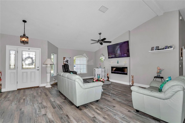 12392 SW 85th Pl, Dunnellon, FL 34432 - living room featuring lofted ceiling, wood finished floors, ceiling fan, and a glass covered fireplace