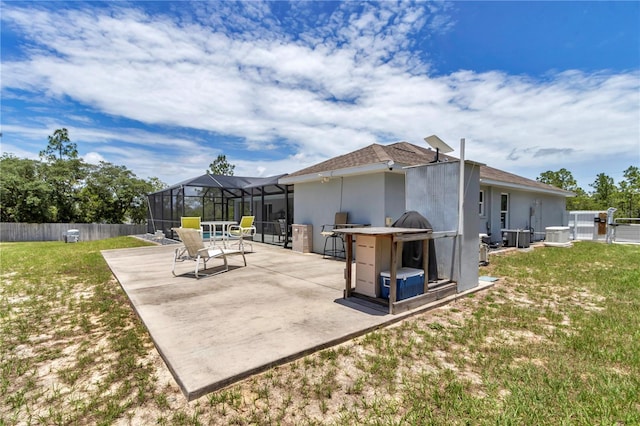 12392 SW 85th Pl, Dunnellon, FL 34432 - back of house with a patio area, a fenced backyard, stucco siding, a lanai, and roof with shingles
