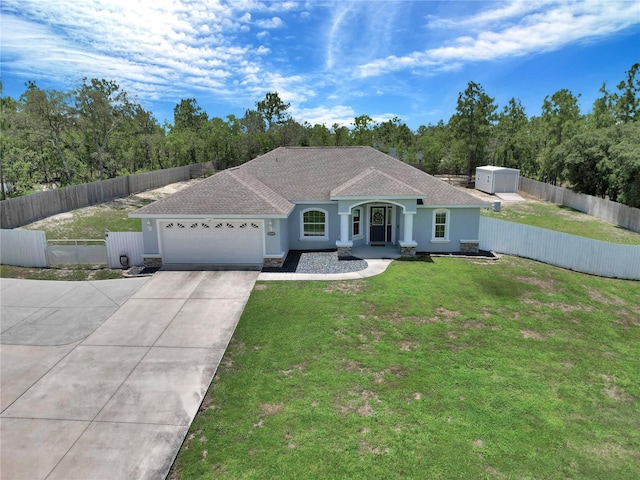 12392 SW 85th Pl, Dunnellon, FL 34432 - ranch-style house featuring a garage, driveway, stucco siding, a shingled roof, and a fenced backyard