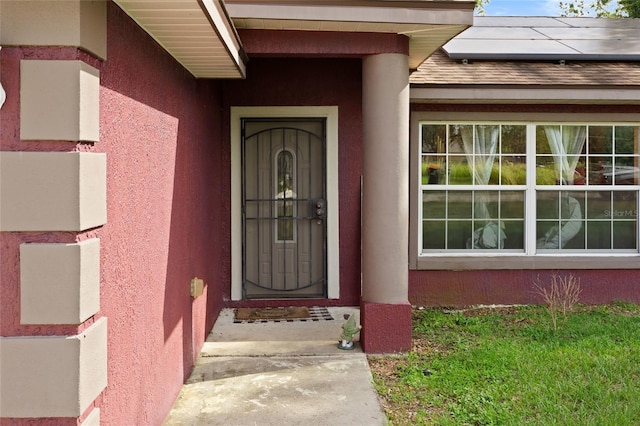 32 Dogwood Drive Loop, Ocala, FL 34472 - entrance to property featuring roof mounted solar panels and stucco siding