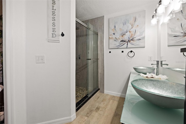 32 Dogwood Drive Loop, Ocala, FL 34472 - bathroom featuring a shower stall, wood finished floors, a textured ceiling, and double vanity