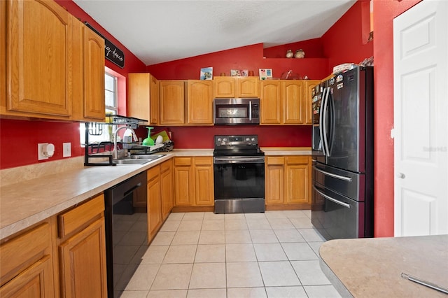 32 Dogwood Drive Loop, Ocala, FL 34472 - kitchen with black appliances, lofted ceiling, light countertops, and light tile patterned floors