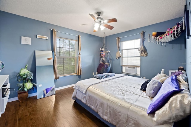 32 Dogwood Drive Loop, Ocala, FL 34472 - bedroom with wood finished floors, multiple windows, ceiling fan, and a textured ceiling