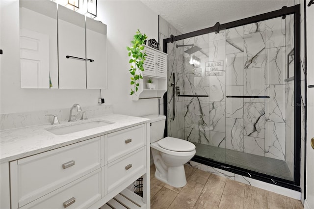 32 Dogwood Drive Loop, Ocala, FL 34472 - full bathroom with a marble finish shower, vanity, wood finished floors, and a textured ceiling