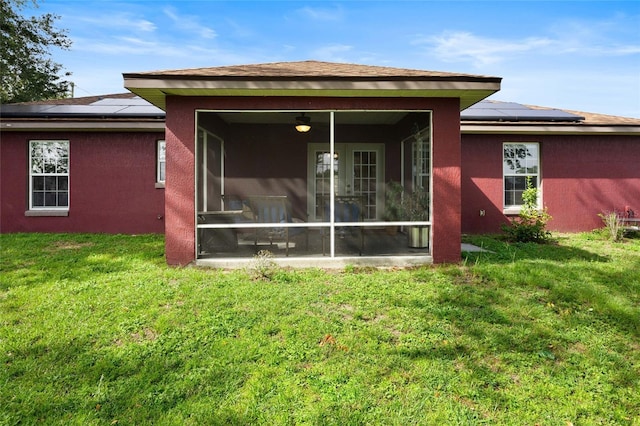 32 Dogwood Drive Loop, Ocala, FL 34472 - back of property featuring a sunroom, solar panels, and stucco siding