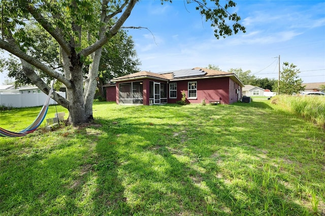 32 Dogwood Drive Loop, Ocala, FL 34472 - back of property featuring a sunroom and solar panels