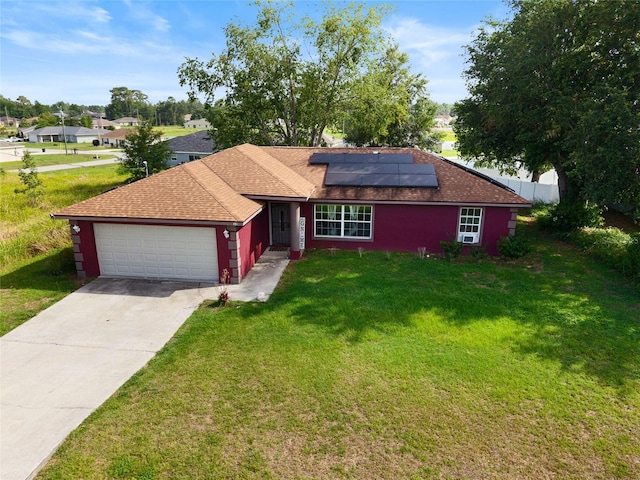 32 Dogwood Drive Loop, Ocala, FL 34472 - ranch-style home with an attached garage, solar panels, a front lawn, driveway, and a shingled roof