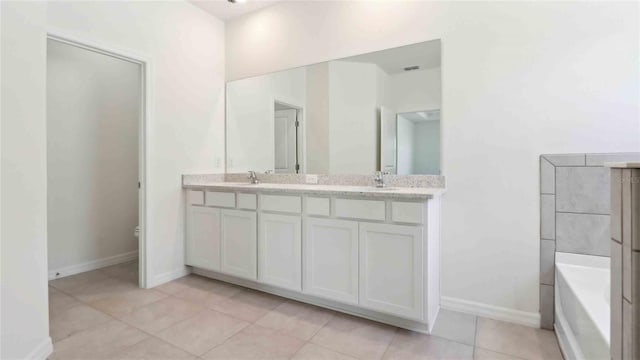 4508 SW 56th Pl, Gainesville, FL 32608 - full bath featuring double vanity, baseboards, a bath, and tile patterned flooring