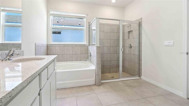 4508 SW 56th Pl, Gainesville, FL 32608 - bathroom featuring a stall shower, a garden tub, tile patterned floors, and vanity