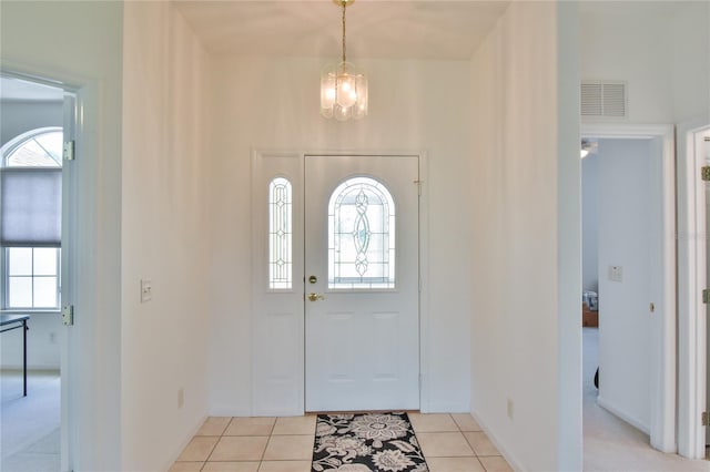 5551 NW 25th Loop, Ocala, FL 34482 - entryway featuring a chandelier and light tile patterned floors
