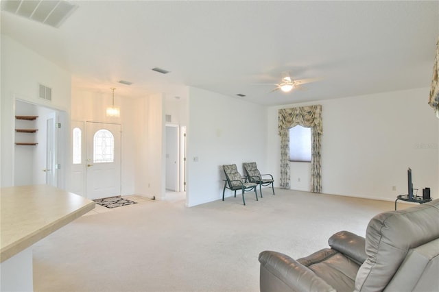5551 NW 25th Loop, Ocala, FL 34482 - carpeted living area featuring healthy amount of natural light, a ceiling fan, and a chandelier