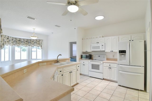 5551 NW 25th Loop, Ocala, FL 34482 - kitchen featuring white appliances, light tile patterned floors, white cabinets, and light countertops