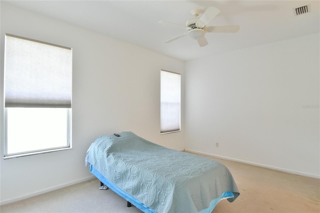 5551 NW 25th Loop, Ocala, FL 34482 - carpeted bedroom featuring multiple windows and a ceiling fan