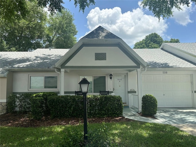 9255 SW 90th Ct Unit B, Ocala, FL 34481 - view of front of property featuring an attached garage, stucco siding, roof with shingles, and driveway