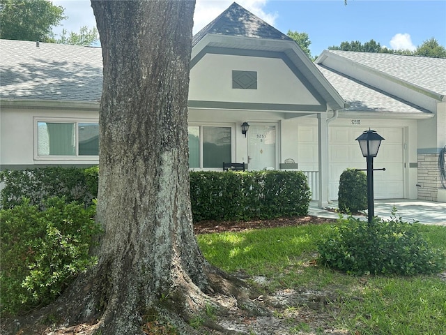 9255 SW 90th Ct Unit B, Ocala, FL 34481 - view of front of home featuring roof with shingles, an attached garage, and stucco siding