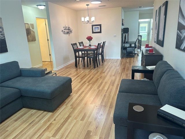 9255 SW 90th Ct Unit B, Ocala, FL 34481 - living area featuring light wood finished floors, a chandelier, and baseboards