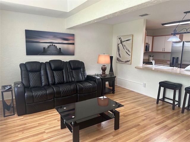 9255 SW 90th Ct Unit B, Ocala, FL 34481 - living room with a textured wall and light wood finished floors