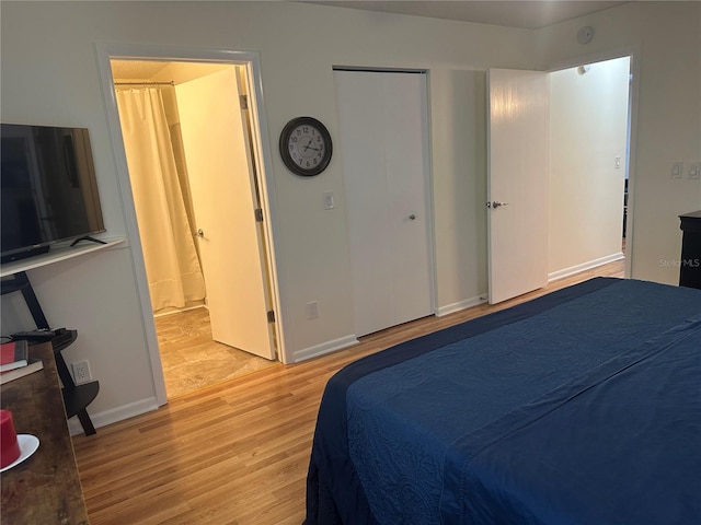 9255 SW 90th Ct Unit B, Ocala, FL 34481 - bedroom featuring light wood-style flooring, baseboards, and ensuite bathroom