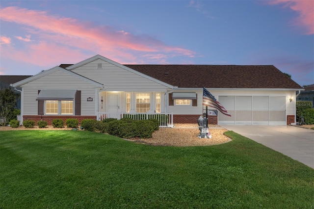 8554 SW 63rd Ct, Ocala, FL 34476 - view of front of home with concrete driveway, brick siding, a lawn, and a garage