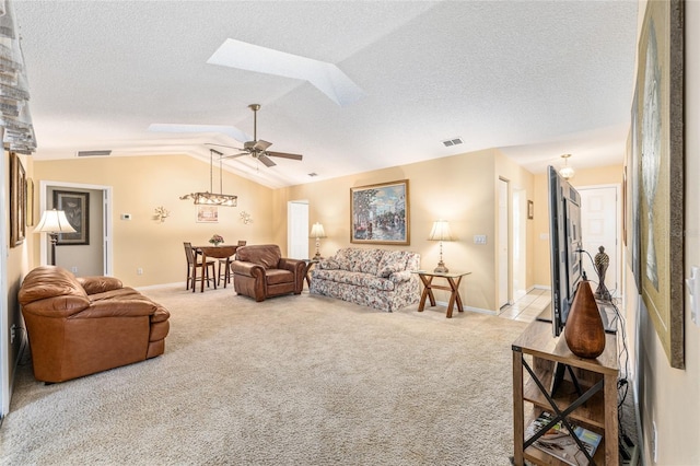 8554 SW 63rd Ct, Ocala, FL 34476 - carpeted living room featuring vaulted ceiling, a ceiling fan, a textured ceiling, and a skylight