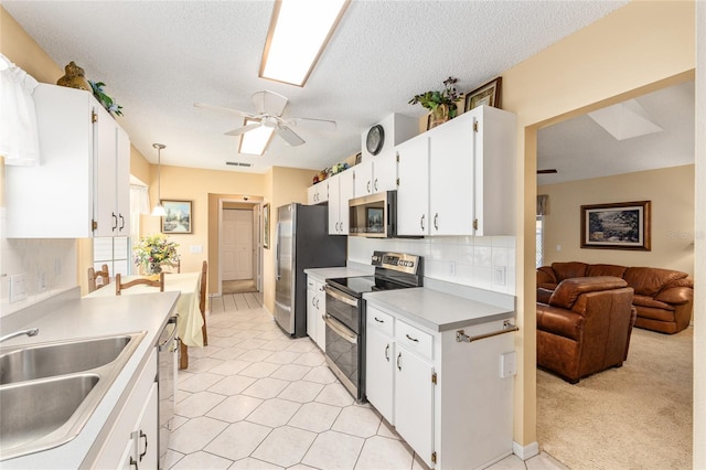 8554 SW 63rd Ct, Ocala, FL 34476 - kitchen with stainless steel appliances, a ceiling fan, white cabinetry, light countertops, and open floor plan