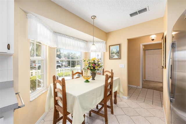 8554 SW 63rd Ct, Ocala, FL 34476 - dining space featuring a textured ceiling and light tile patterned flooring