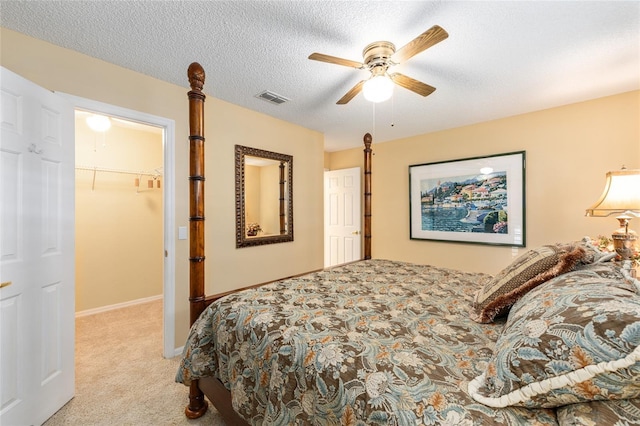 8554 SW 63rd Ct, Ocala, FL 34476 - bedroom with carpet flooring, a spacious closet, a ceiling fan, and a textured ceiling