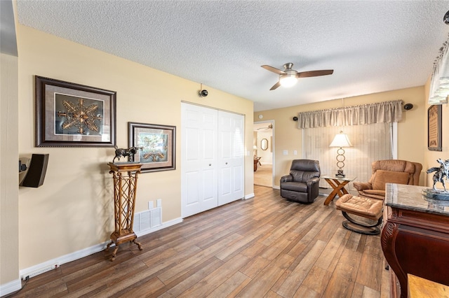 8554 SW 63rd Ct, Ocala, FL 34476 - living area with wood finished floors, a ceiling fan, and a textured ceiling
