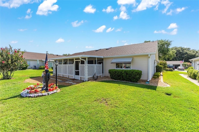 8554 SW 63rd Ct, Ocala, FL 34476 - back of property with a sunroom and a lawn