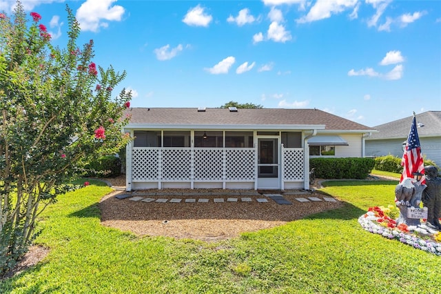 8554 SW 63rd Ct, Ocala, FL 34476 - back of property with a sunroom, a lawn, and roof with shingles