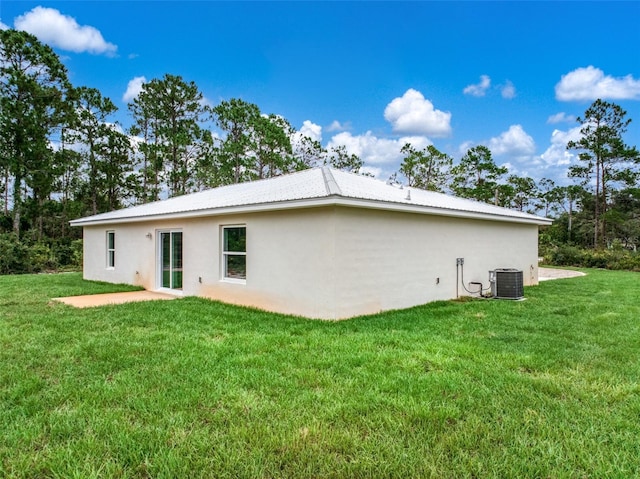 9131 Canter Path, Sebring, FL 33870 - rear view of house with stucco siding, a yard, and a patio area
